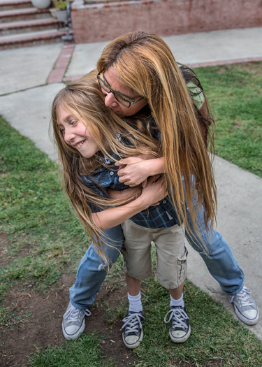 Vincent Dodd's mom hugging him  from behind.
