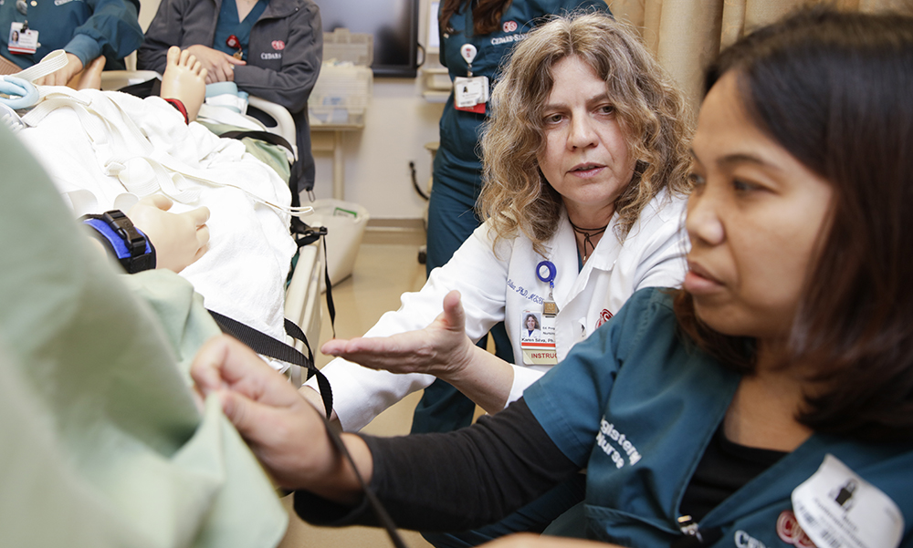 Cedars-Sinai education program coordinator, Karen Silva teaching a nurse.