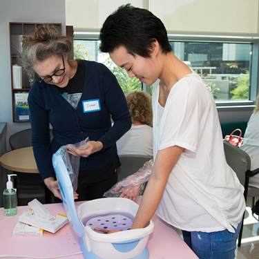 Breast cancer patient Audrey Youn enjoys a paraffin wax treatment.