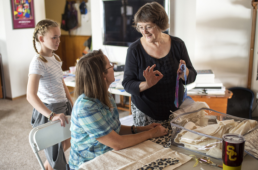 Dorothy Williams and her granddaughter Emma discuss patterns with Kathleen Boeck, a Cedars-Sinai employee.