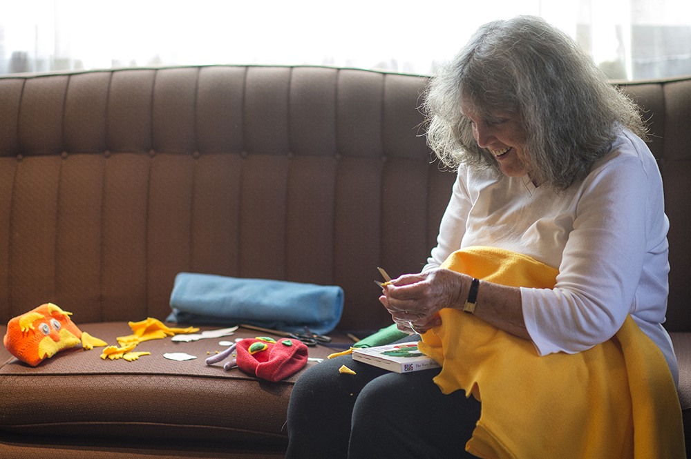 Joy Peterman cuts tiny bits of fabric to create a Lorax costume for Cedars-Sinai's NICU babies.
