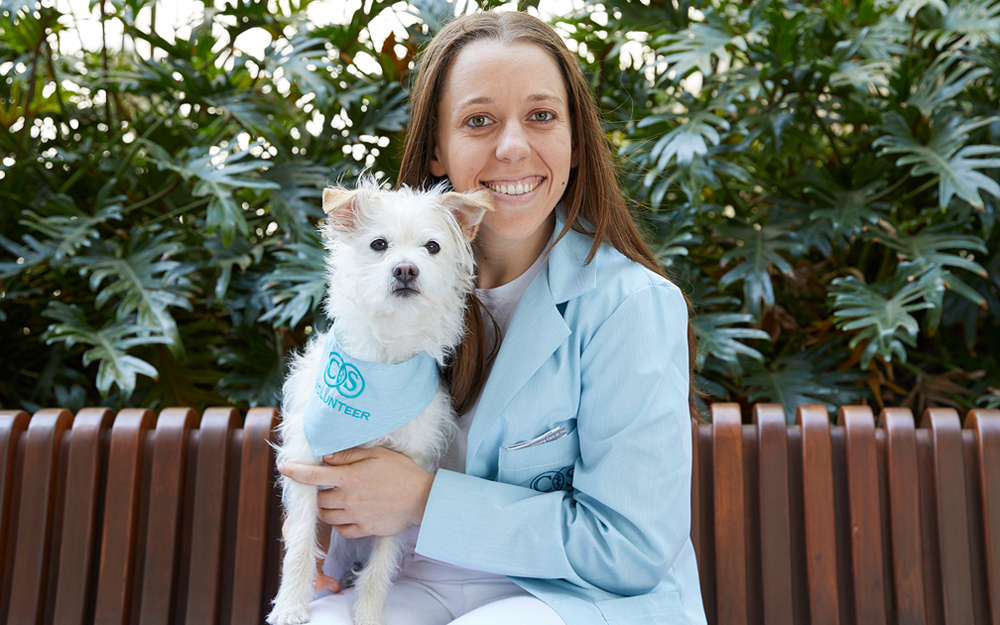 Cedars-Sinai POOCH Volunteer Julie Housman and her fluffy terrier Dodger.