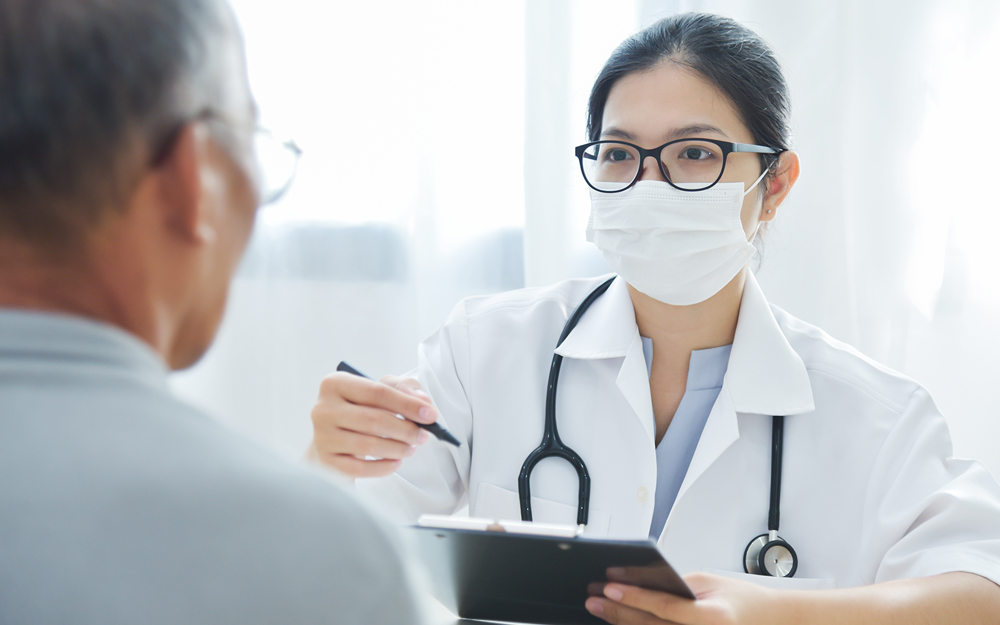 Woman doctor going over results with man.
