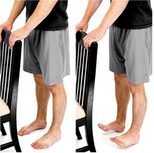 Man holding a chair doing standing toe raises.