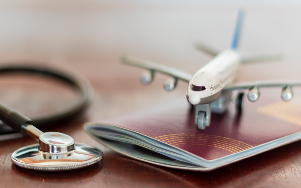 Toy airplane on top of a book next to a stethoscope
