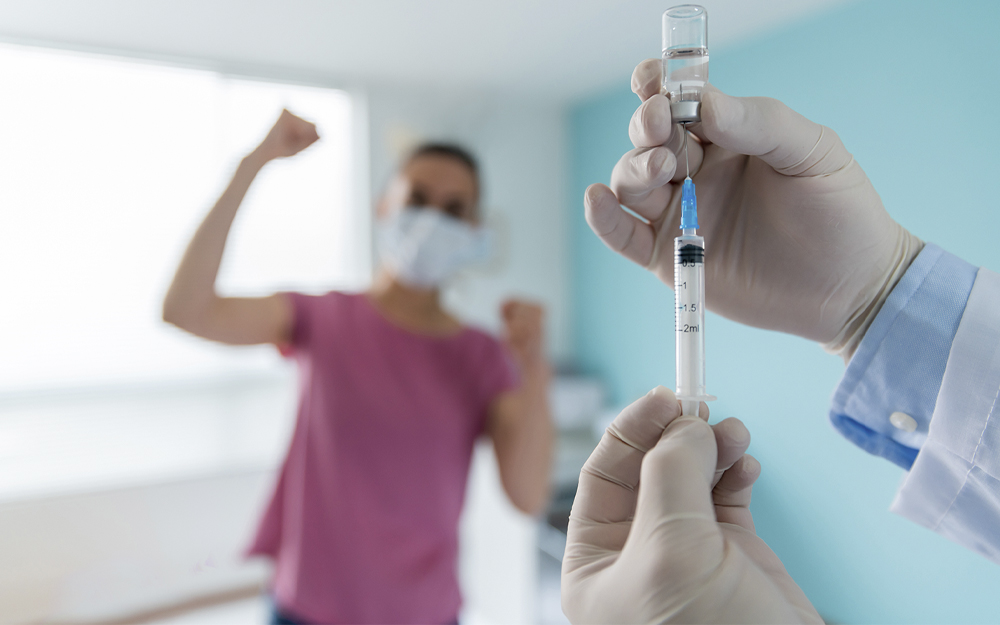 Woman looking very happy about getting the COVID-19 vaccine.