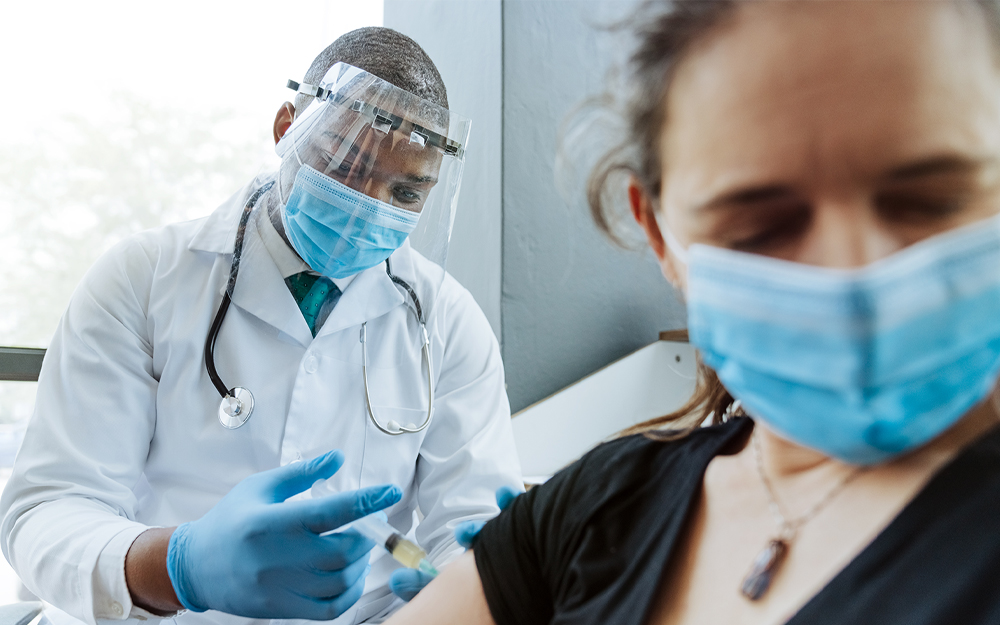A person getting vaccinated while overcoming the fear of needles