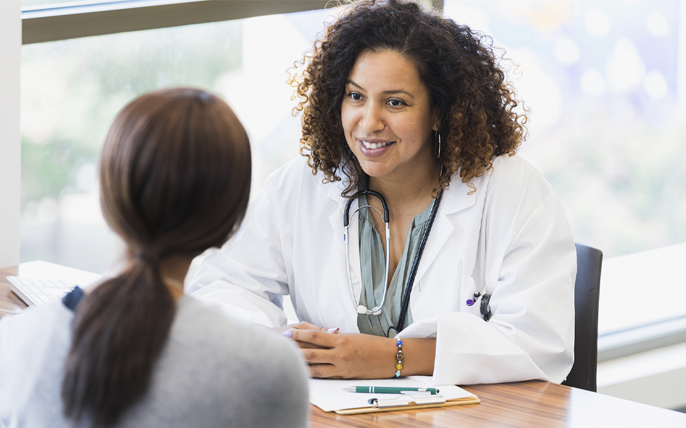 A woman doctor listening attentively to a patient