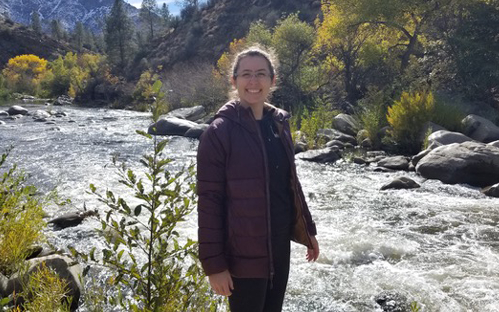 Sarah Stockman standing by a river.