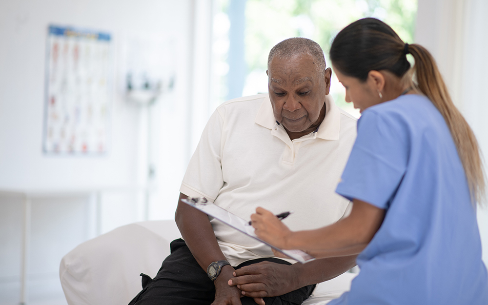 Doctor reviewing medical chart with elderly patient