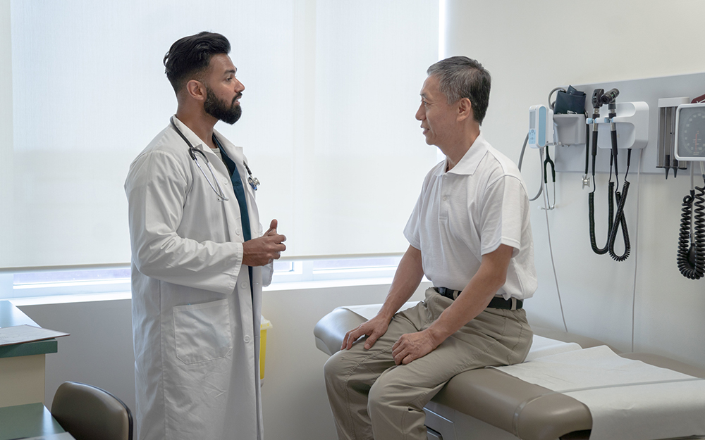 Elderly man speaking with his doctor
