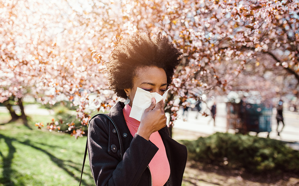 A woman blowing her nose.