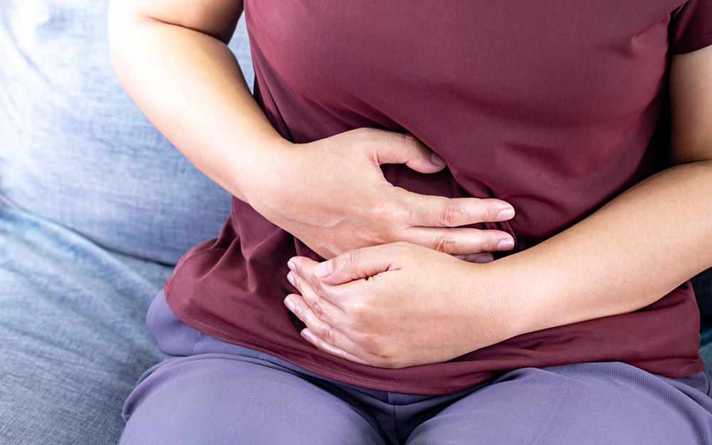 Woman in pain holding her stomach area
