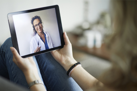 Person speaking with their doctor on a tablet.