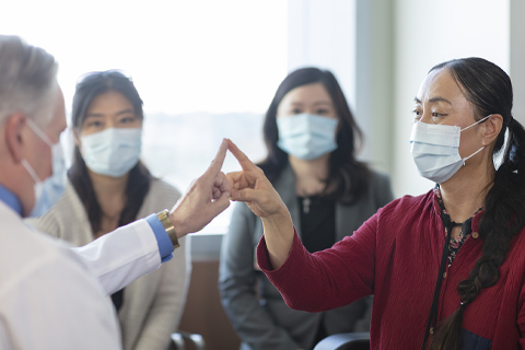 Doctor and patient touching fingers.